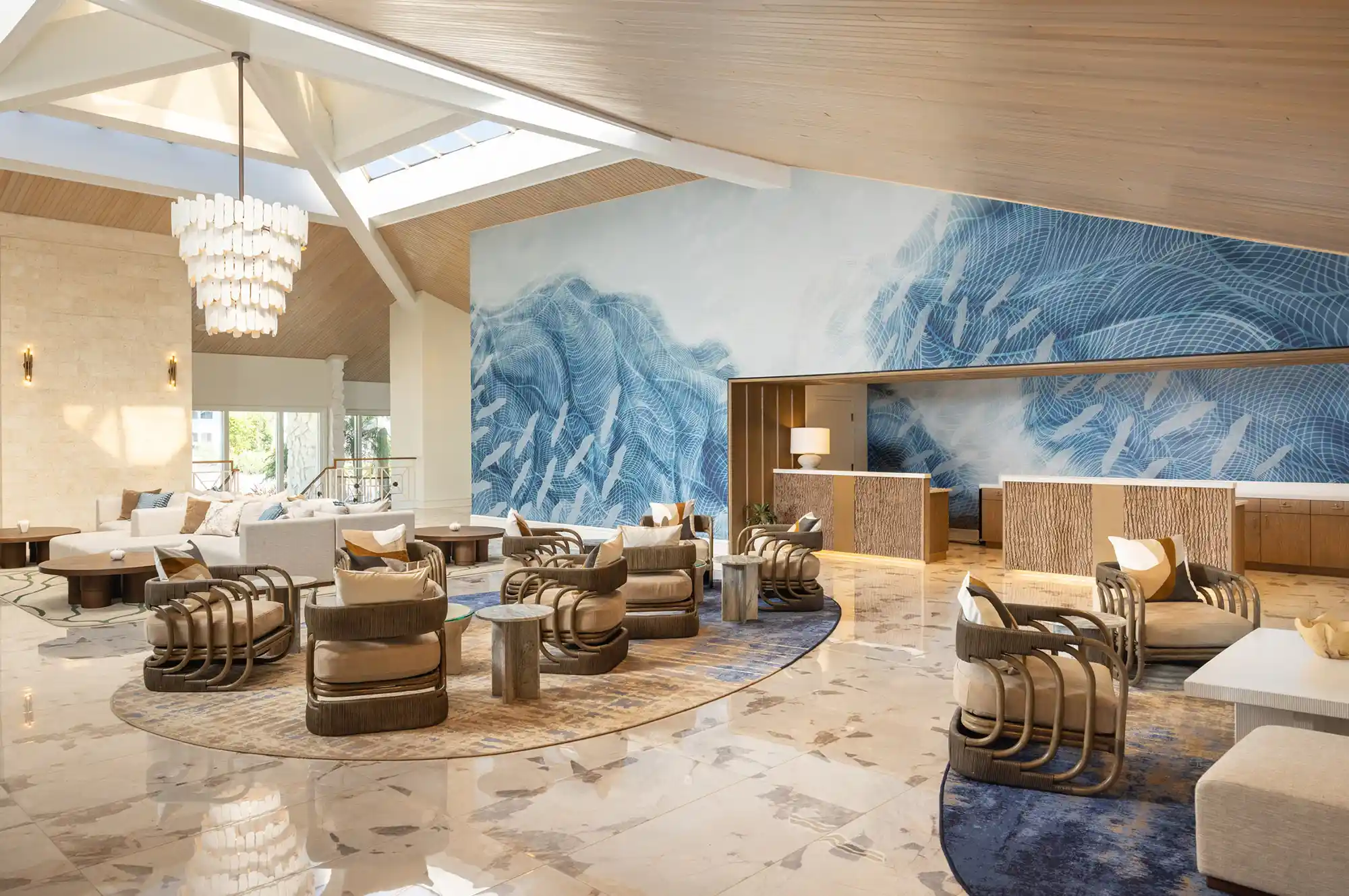 Modern resort lobby at Saddlebrook featuring contemporary furniture, custom mural wall, and natural light from ceiling windows.