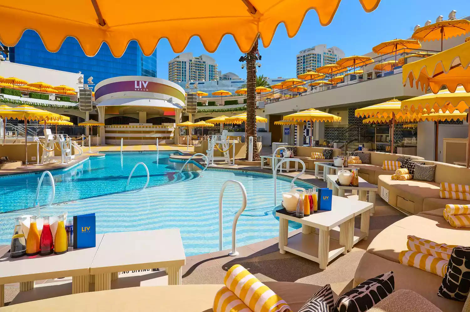Close-up of premium bottle service setup and fresh mixers inside a private cabana at LIV Beach.