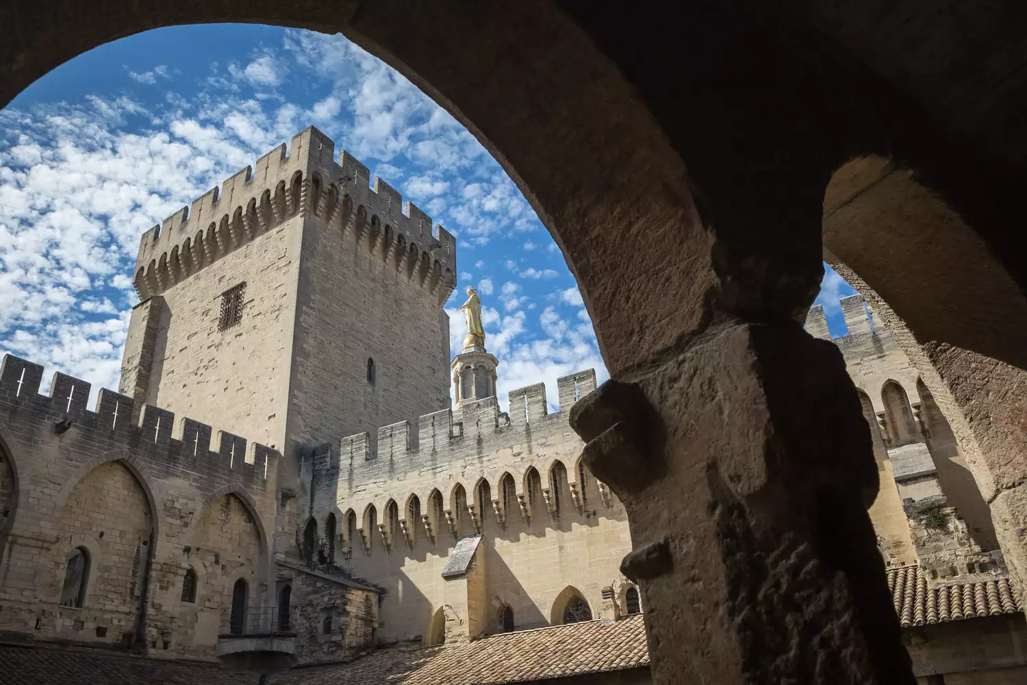A wide angle view of the Gothic architecture of the Palace Of The Popes in Avignon.