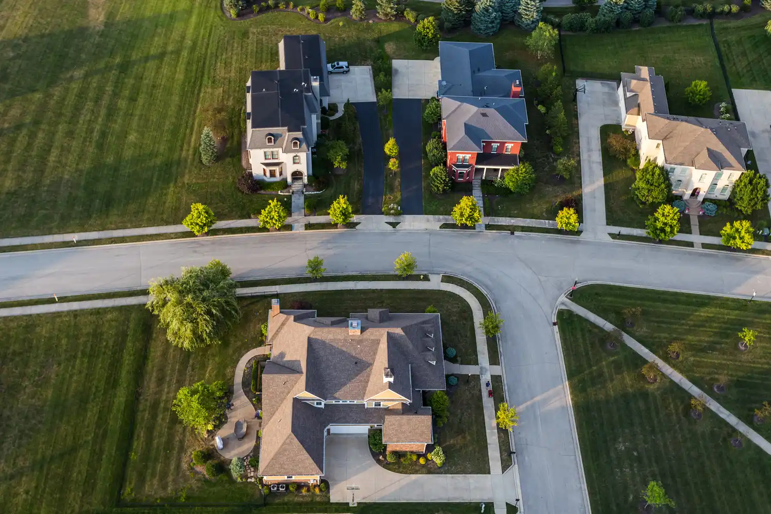 Aerial view of a suburban neighborhood with houses and streets intersecting