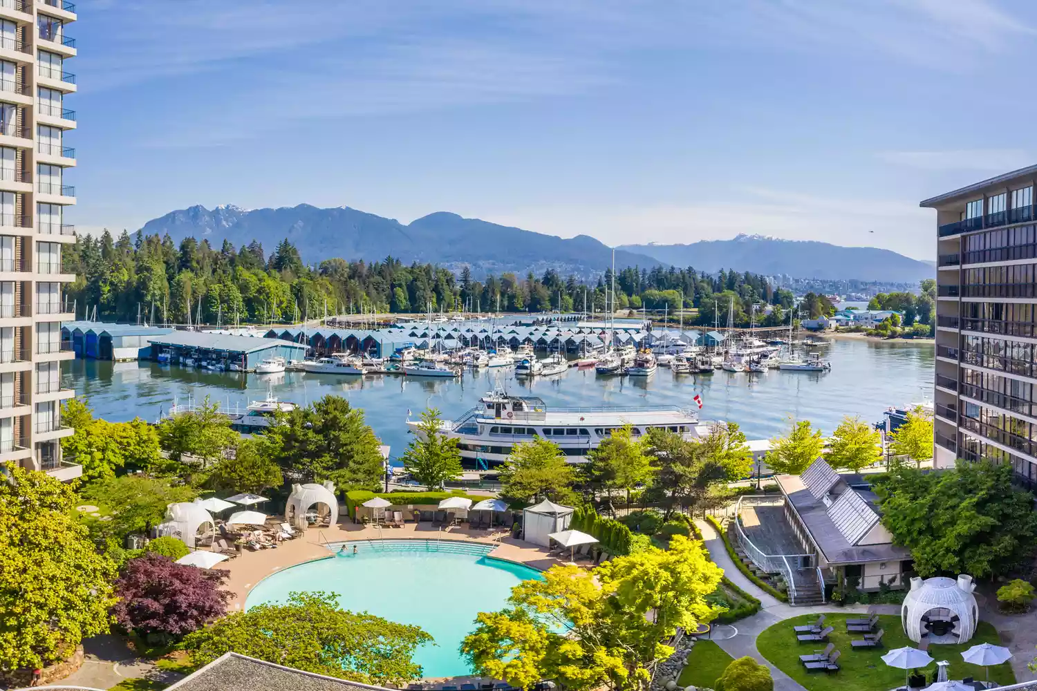 Outdoor swimming pool at the Westin Bayshore overlooking the Vancouver harbor and mountains.