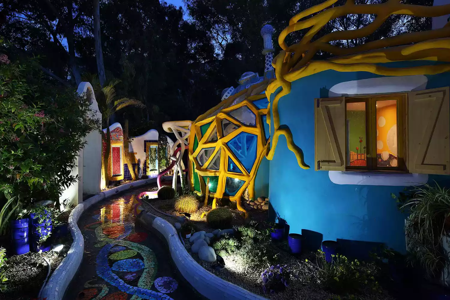 The exterior of The Color House in Cyprus, a uniquely styled dome surrounded by garden foliage.