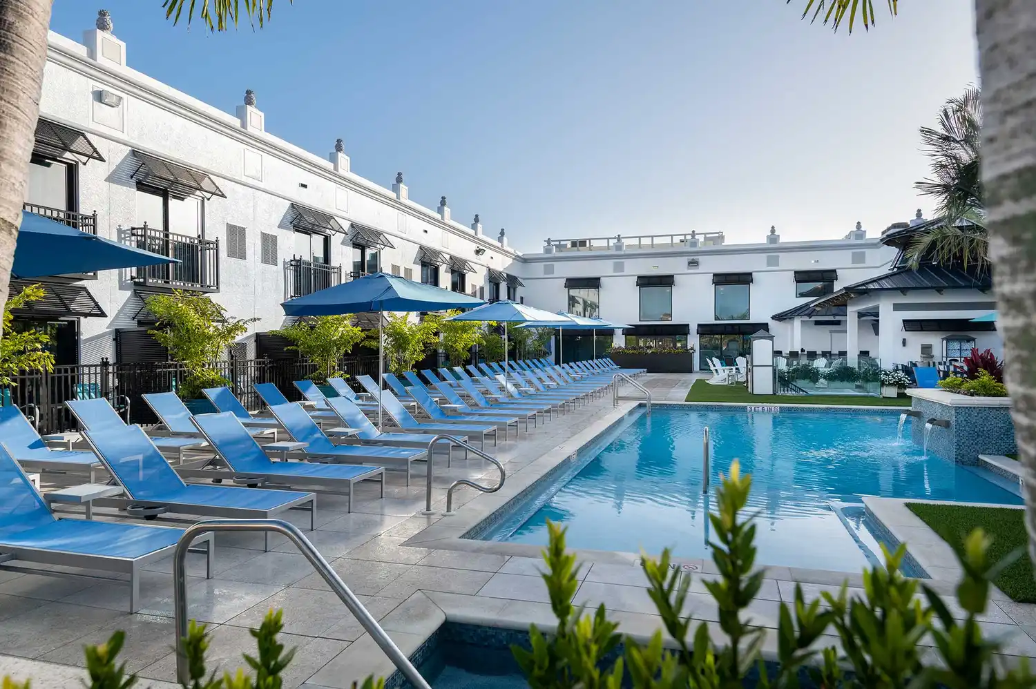 Sun-drenched swimming pool area and lounge chairs at the Inn on Fifth Naples
