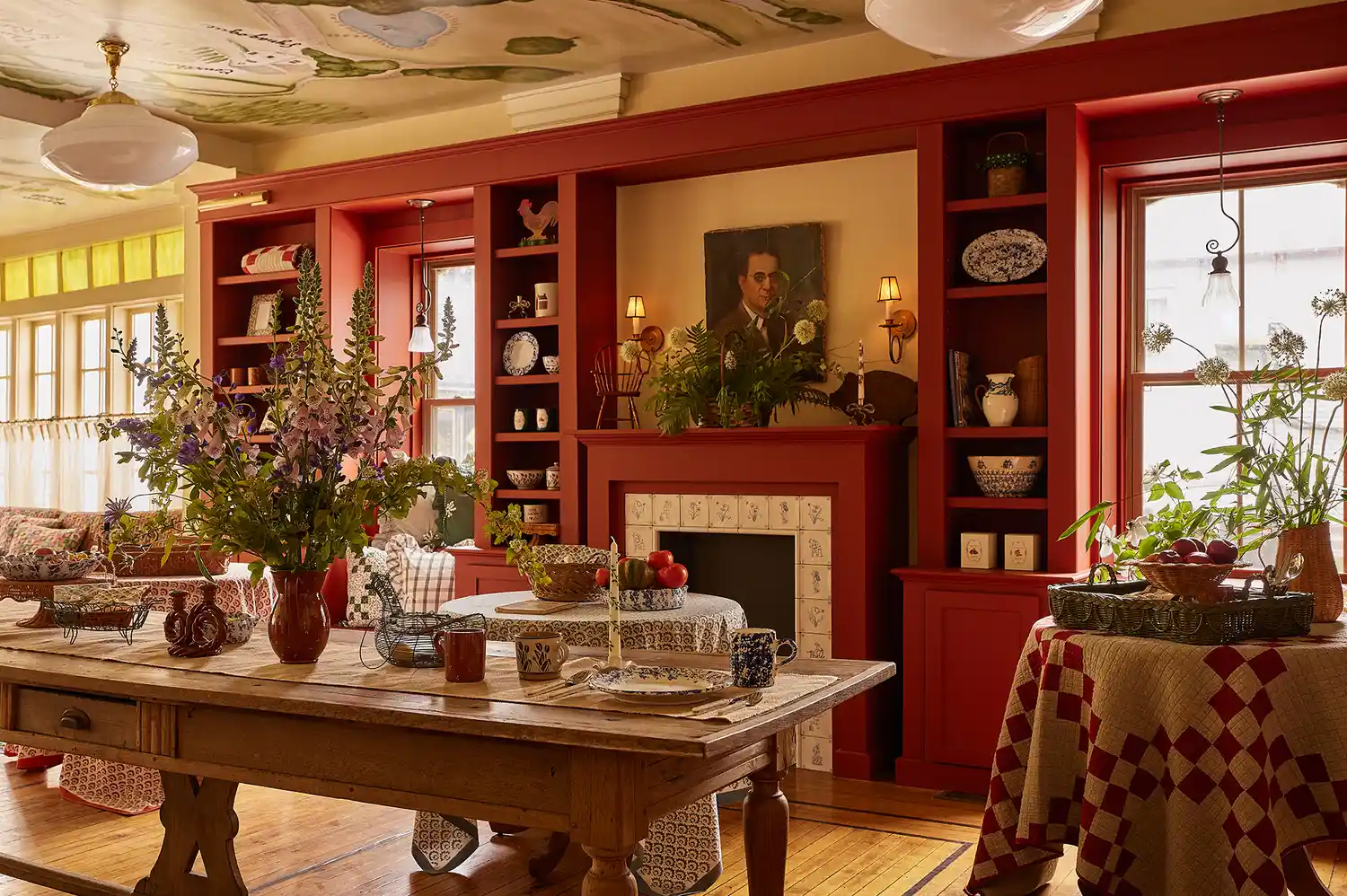Interior of the country store with red walls, flowers, and shelves stocked with decorative items.