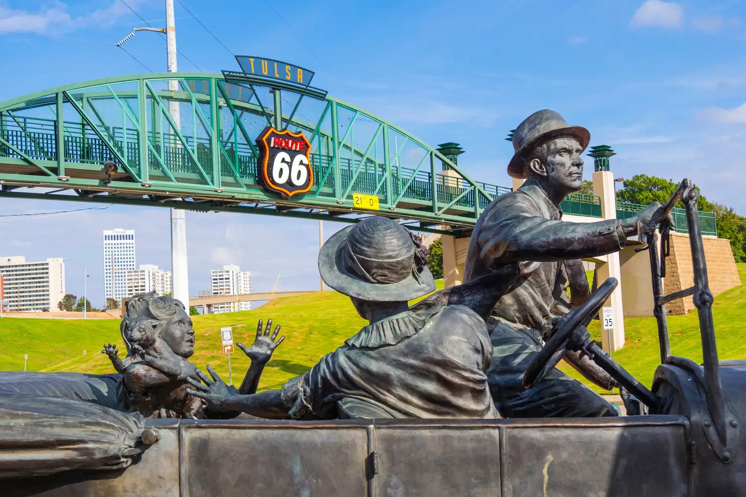 Tulsa's Cyrus Avery Centennial Plaza featuring a sculpture of a family in a car with a Route 66 sign.