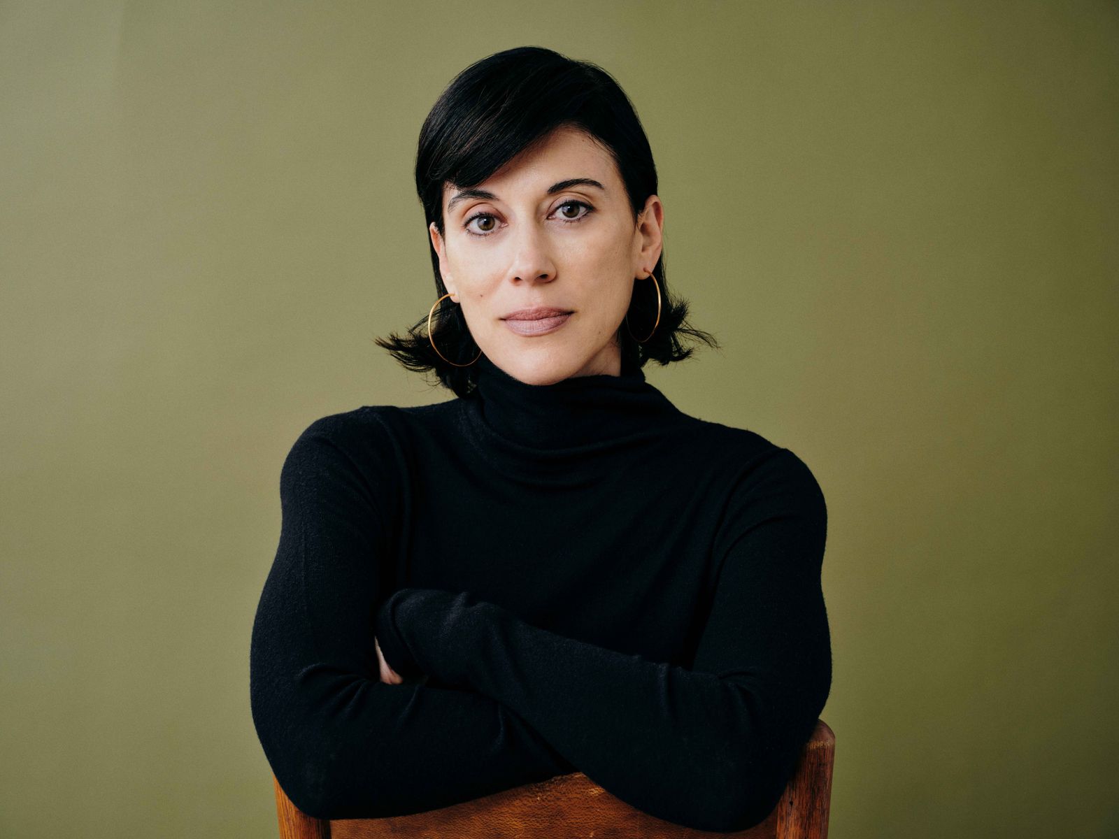 A professional portrait of Cherien Dabis smiling.