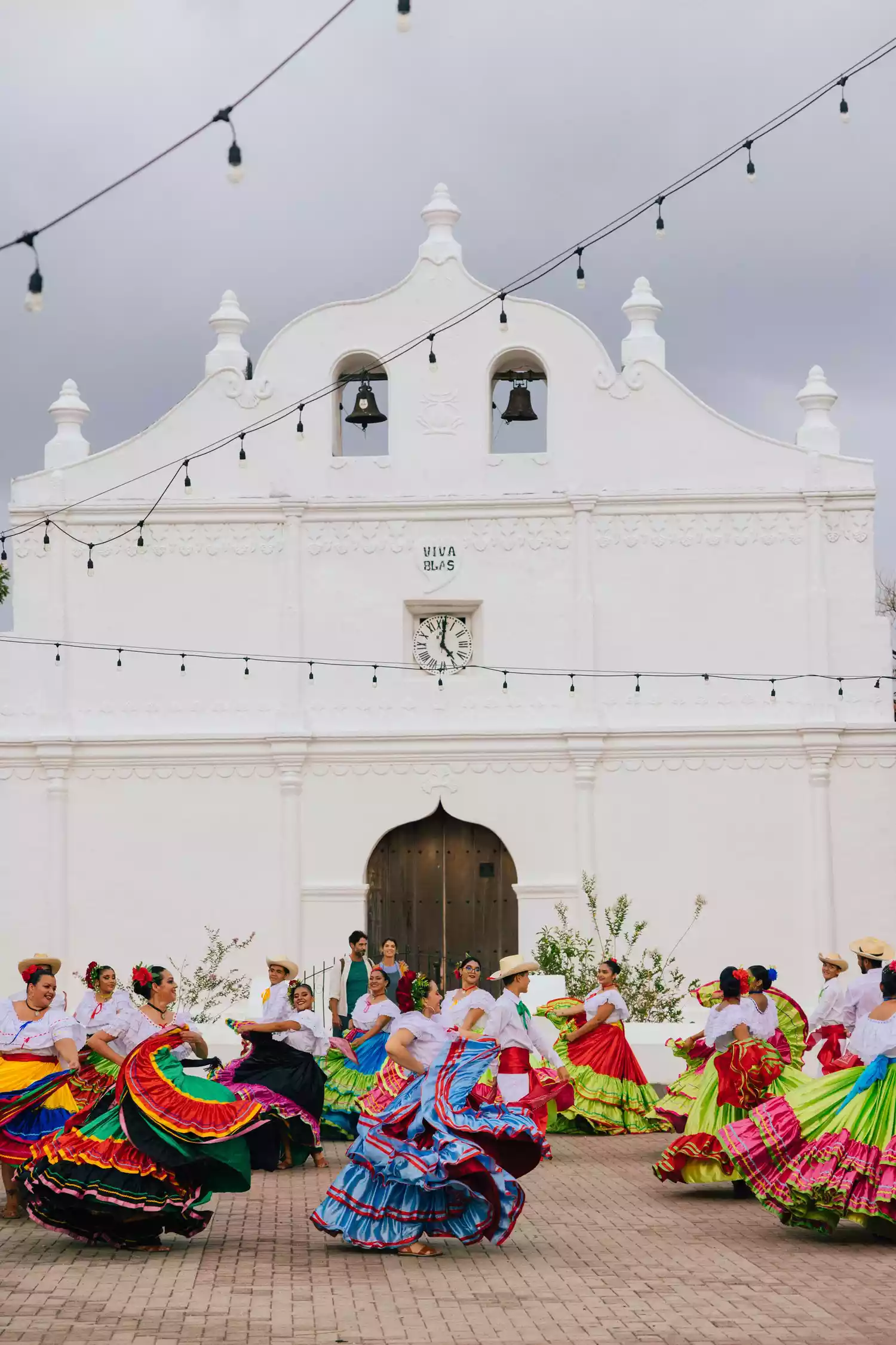 Traditional dancers in colorful costumes performing in a public plaza in Guanacaste.