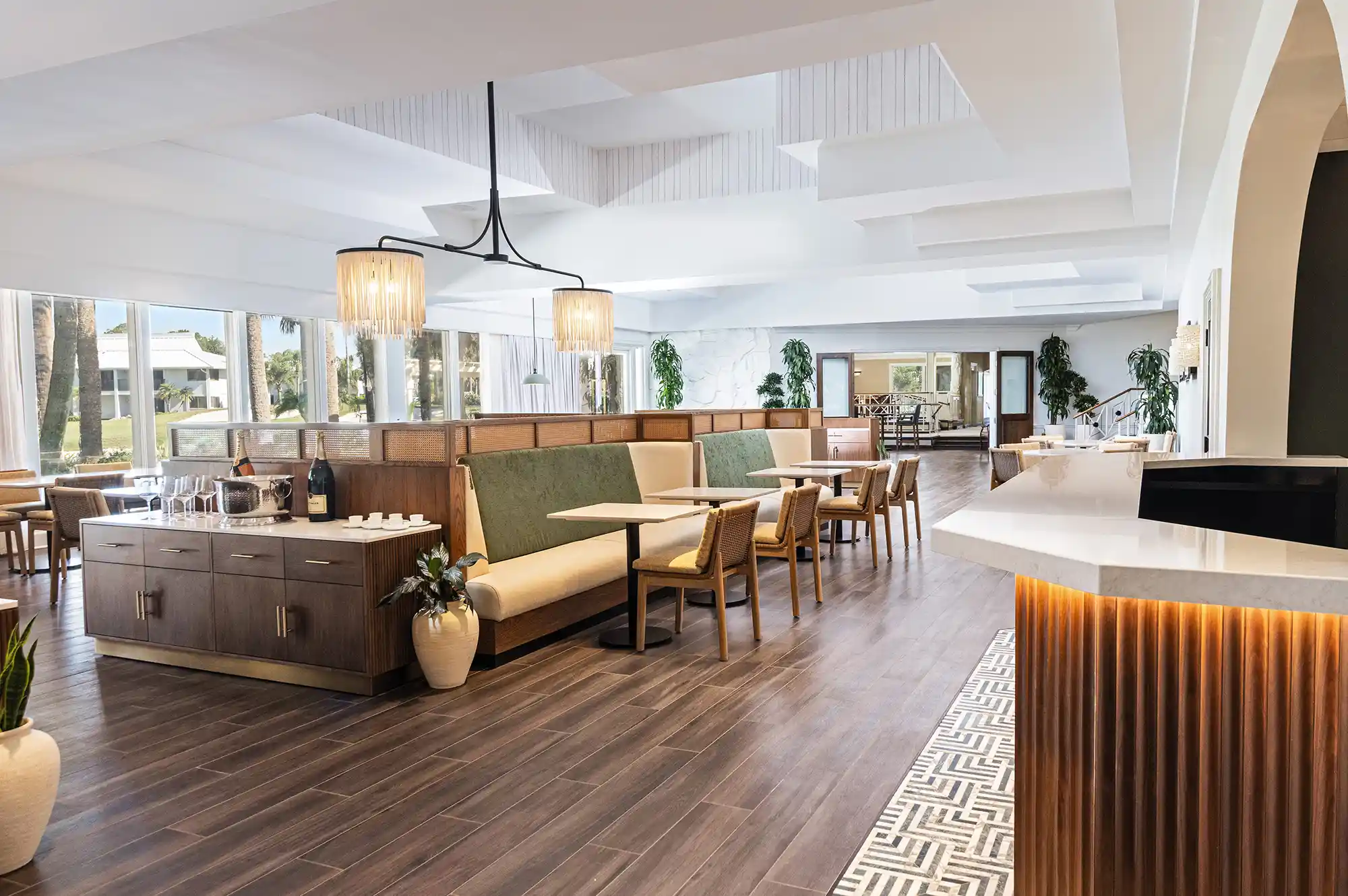 Interior of a modern resort restaurant with sleek booths, designer lighting, and wood accents.