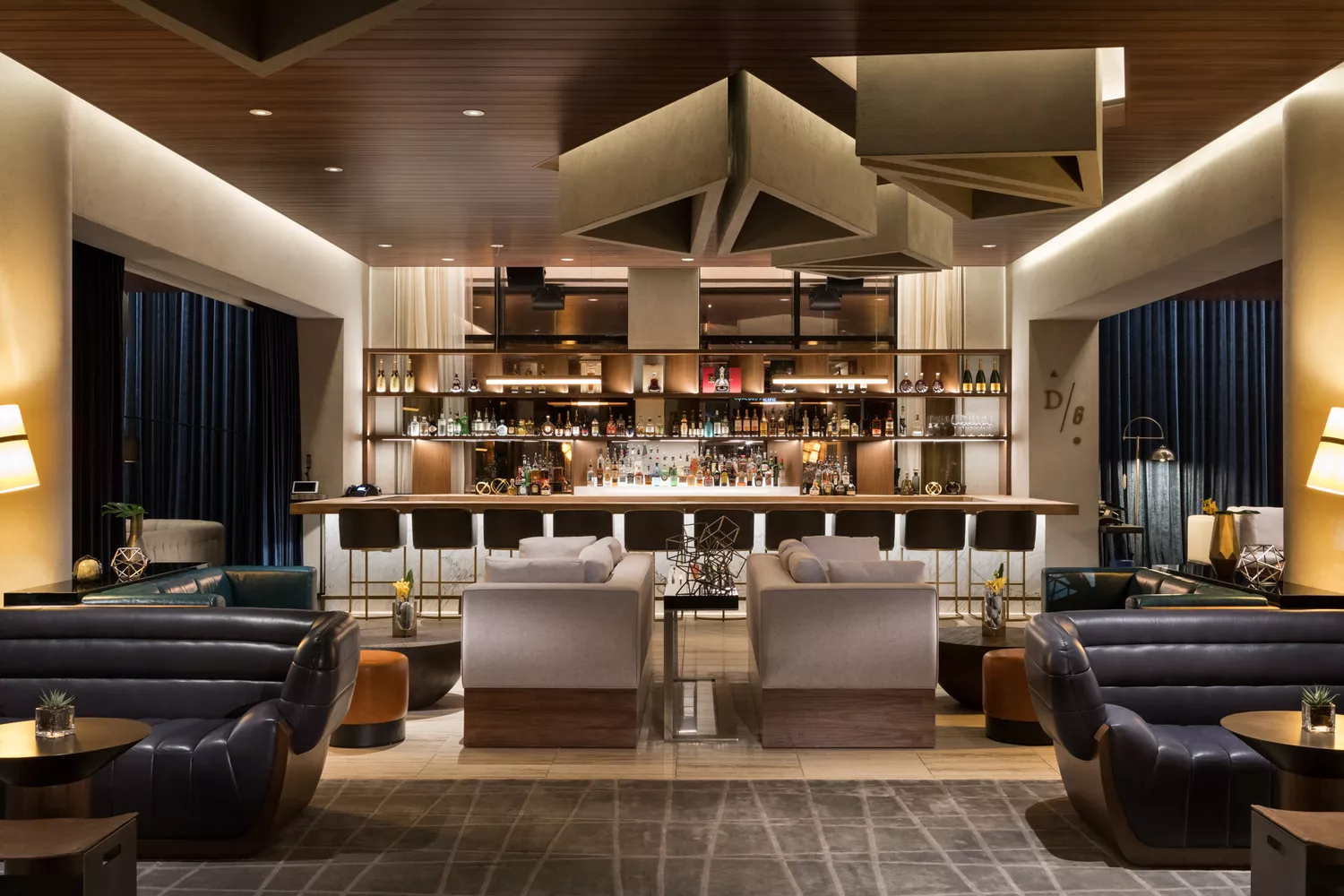A stylish and dimly lit modern bar at The Douglas hotel.