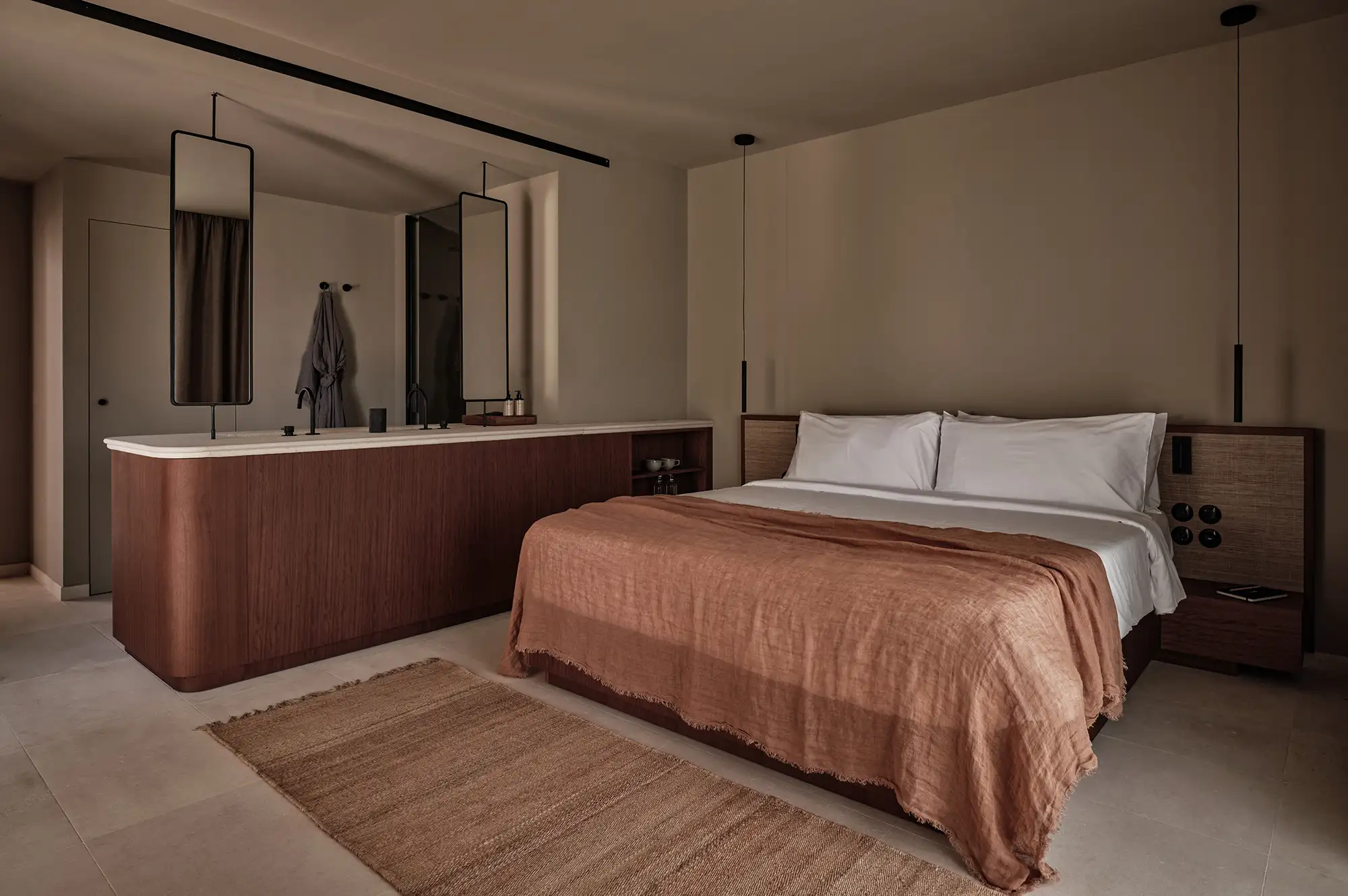 A minimalist bedroom at Oku Andalusia with a double bed, clean lines, and neutral earth tones.