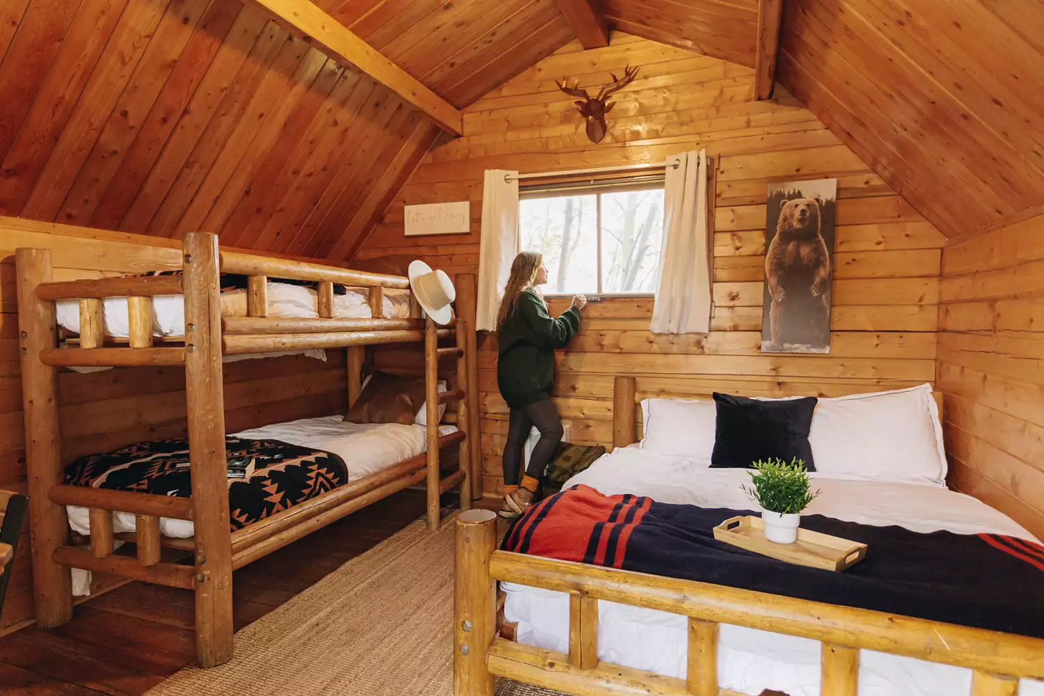 The warm, wood-paneled interior of a modern camping cabin.