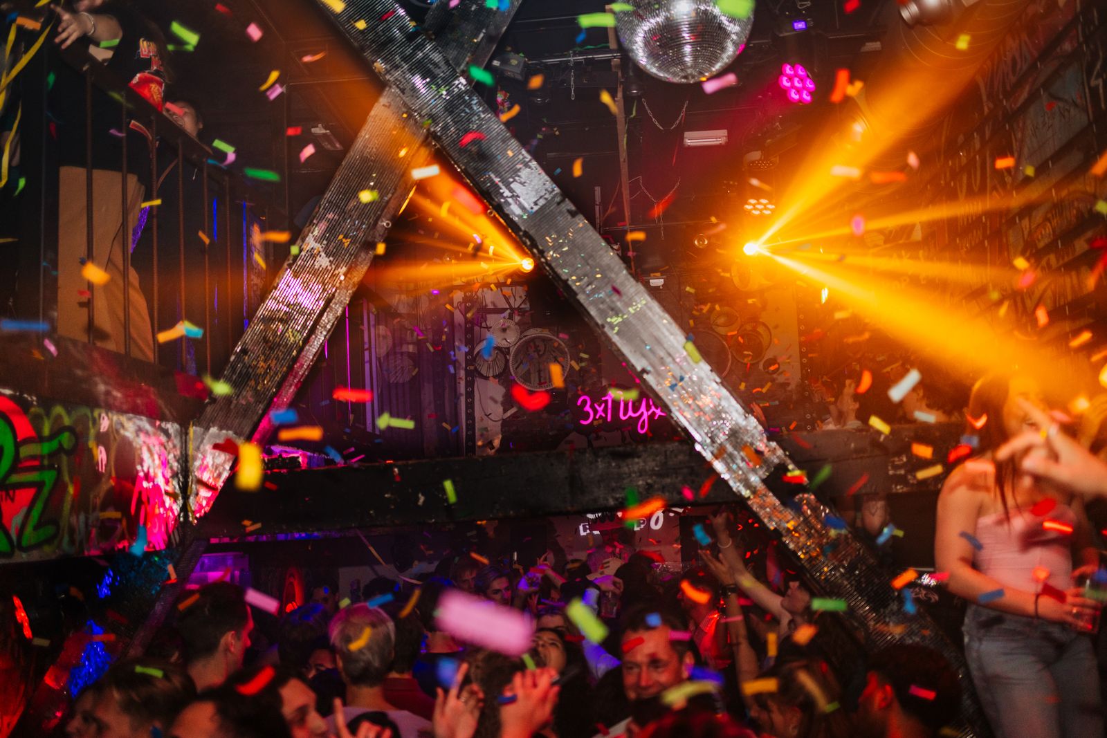 Crowd of people enjoying a vibrant nightlife scene in a club setting.