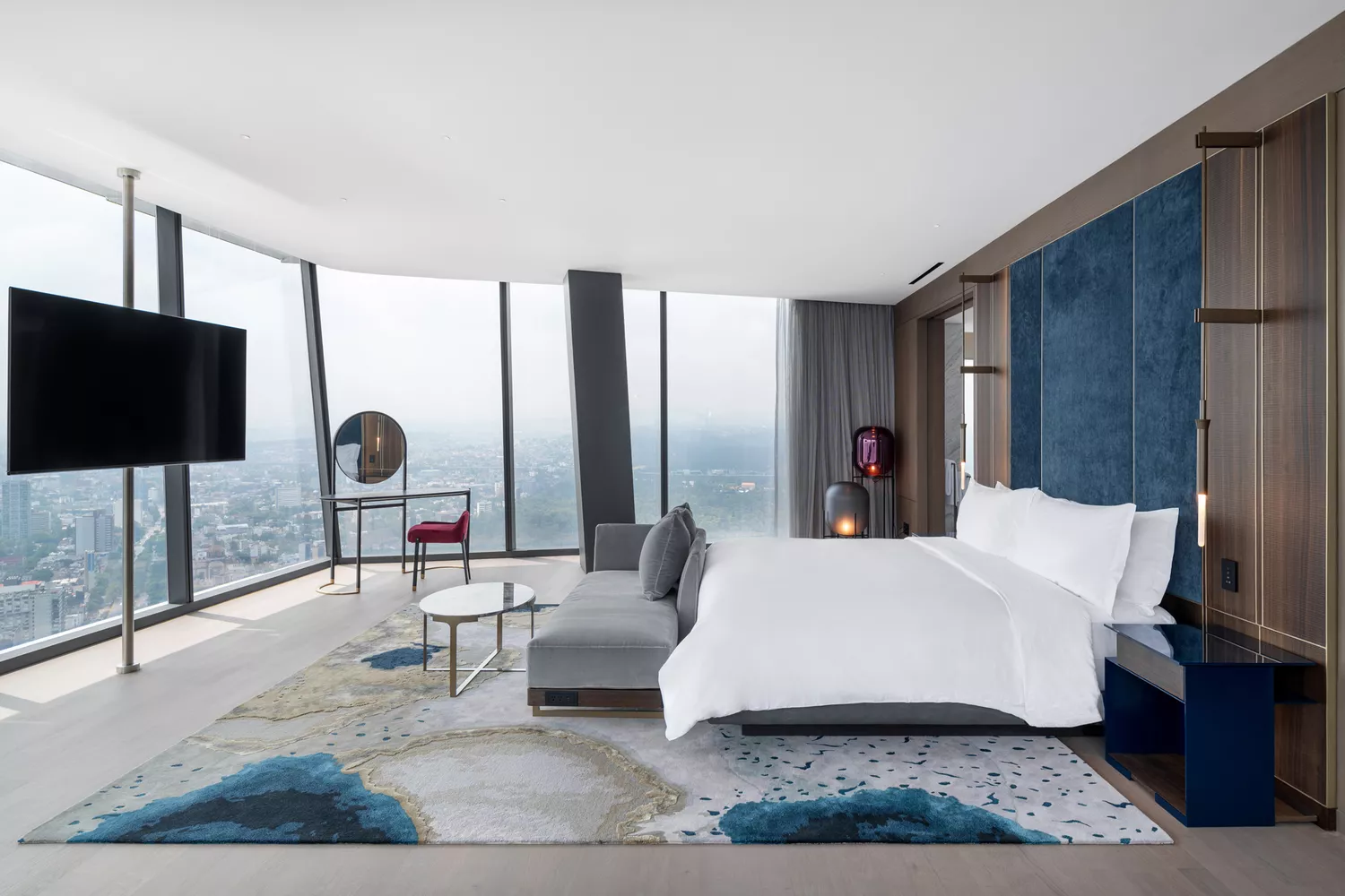 Grand suite at the Ritz Carlton Mexico City featuring panoramic floor-to-ceiling city views.