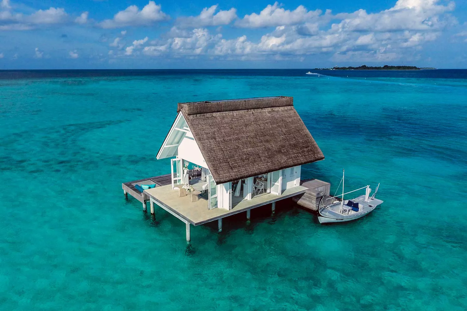 Aerial view of a secluded overwater wedding pavilion surrounded by clear blue water in the Maldives.