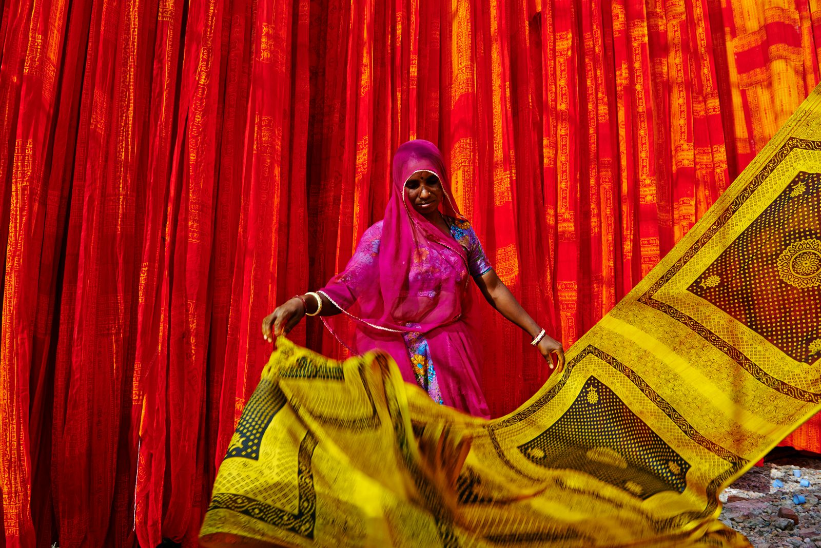 A close-up of a classical Indian dancer in traditional costume and makeup.