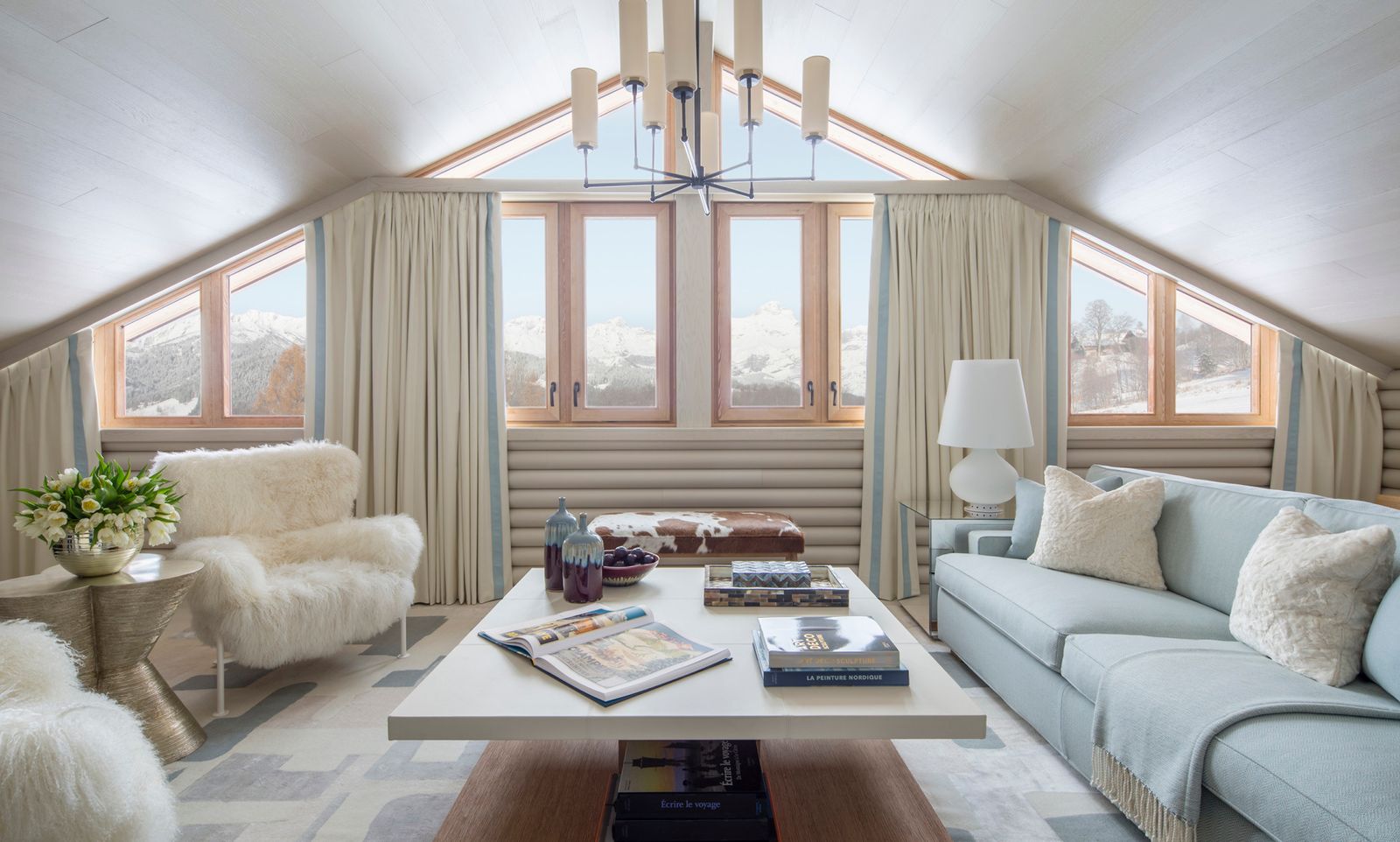 Close-up of a refined hotel interior with curated books and designer coffee table decor.