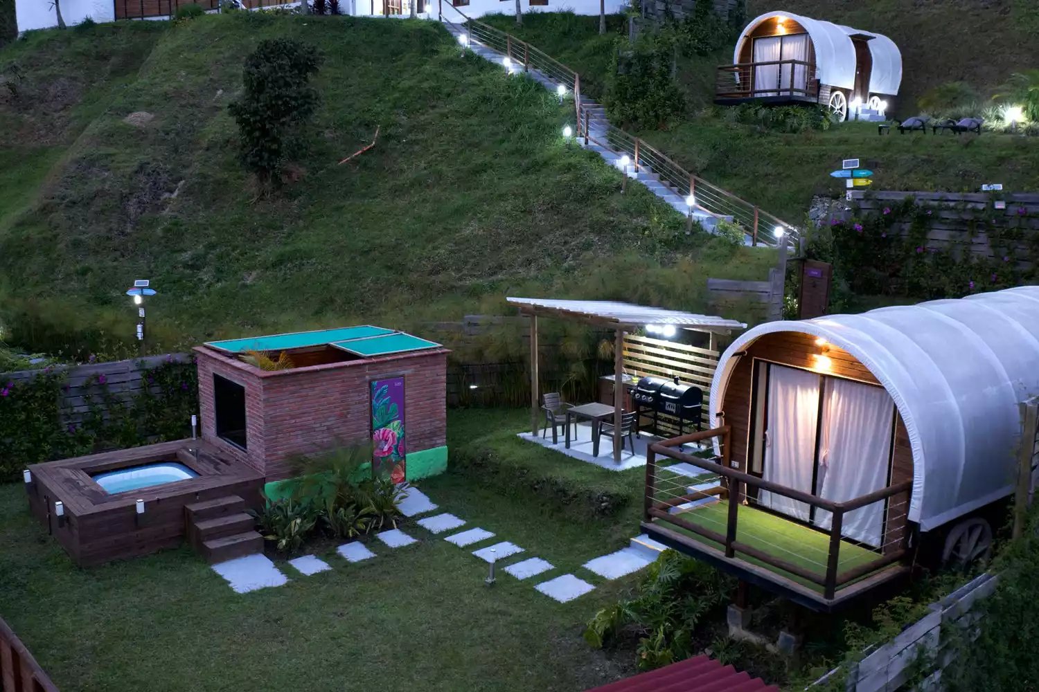 A luxury tented wagon with an outdoor hot tub and dining area at Glamping La Cepa in Colombia.
