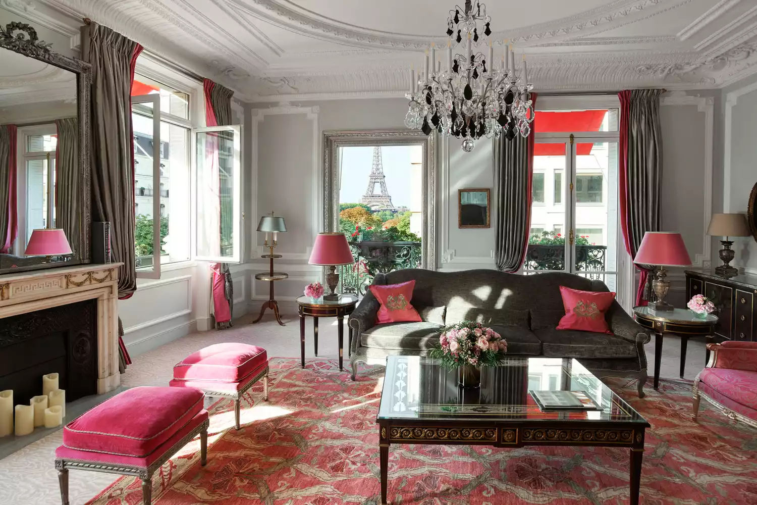Opulent luxury suite at Hôtel Plaza Athénée featuring classic French windows and red decor accents.